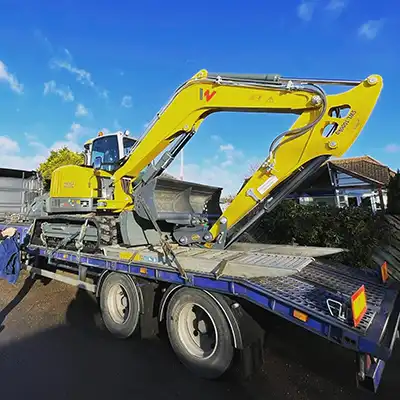 excavator on a flat bed truck